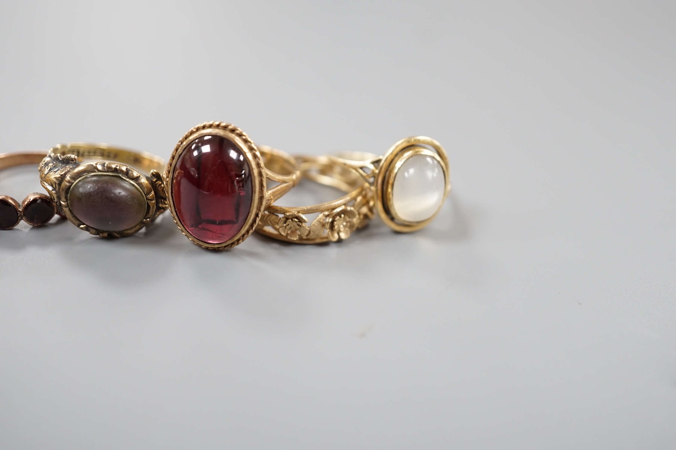 Six assorted Victorian and later 9ct gold or 9ct gold and gem set dress rings, including cabochon garnet and foliate band and a yellow metal and moonstone ring.